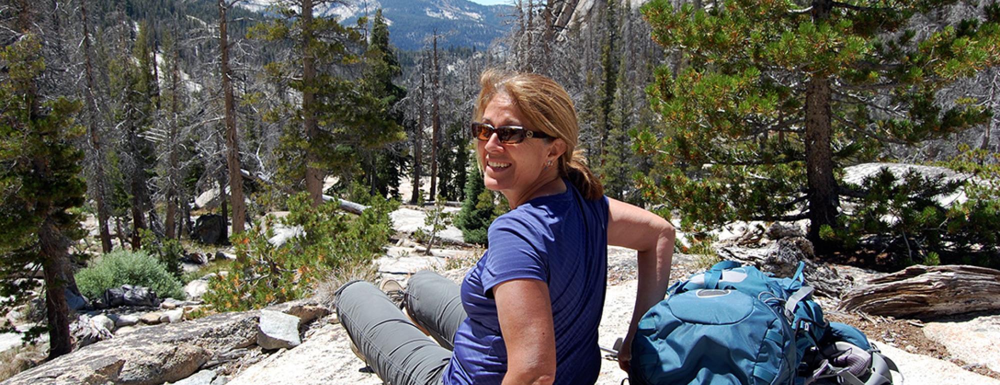 Isabel Montanez sitting on a mountain.