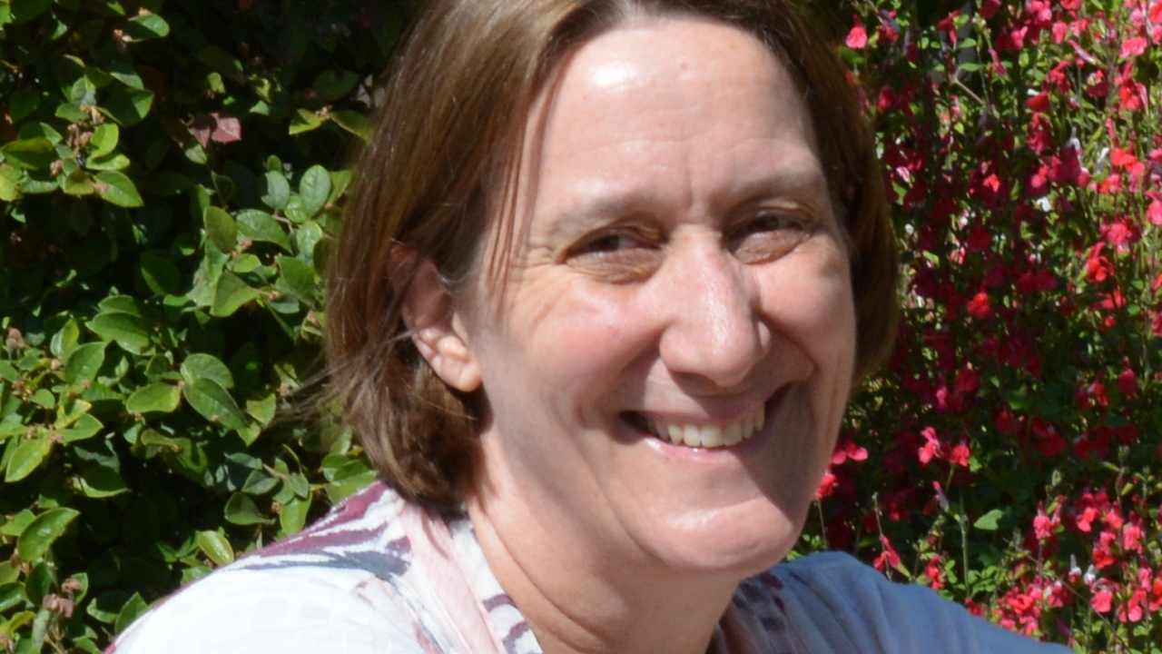 Magali Billen smiling in front of flowers
