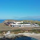 A laboratory sits on the coast with the sea in the background.