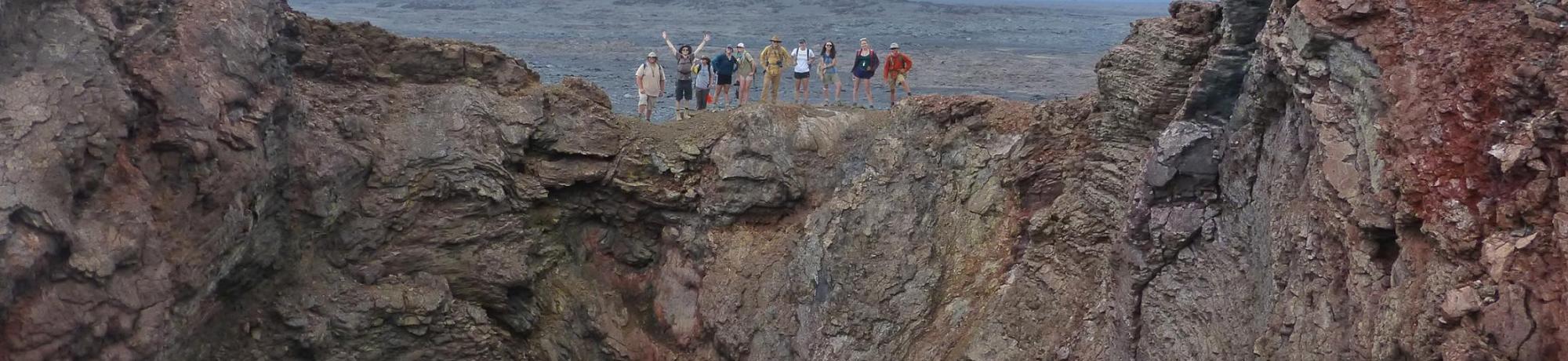 Group of EPS undergraduate students standing on the rim of a crater in Hawaii.